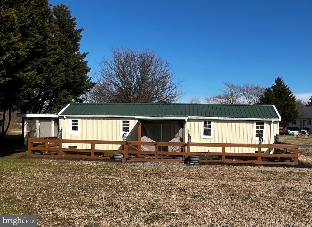 manufactured / mobile home featuring metal roof and a deck