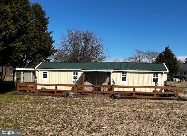 manufactured / mobile home featuring metal roof and a deck