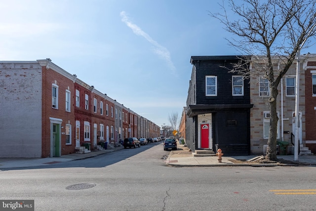 view of road featuring entry steps, curbs, and sidewalks