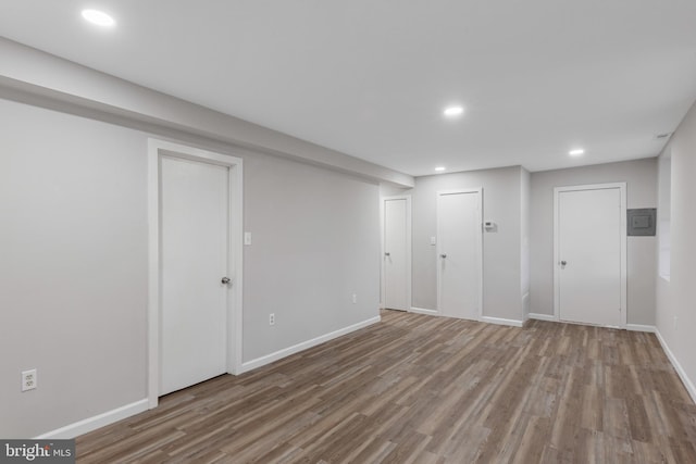 below grade area featuring recessed lighting, baseboards, and wood finished floors