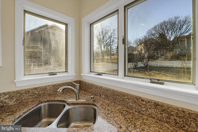 interior details with stone counters and a sink