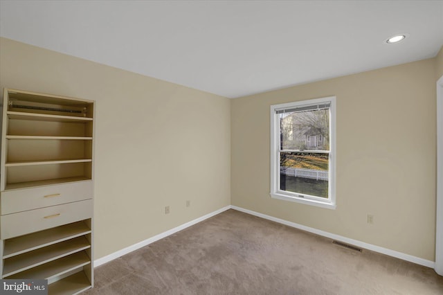 unfurnished bedroom with carpet, visible vents, baseboards, and recessed lighting