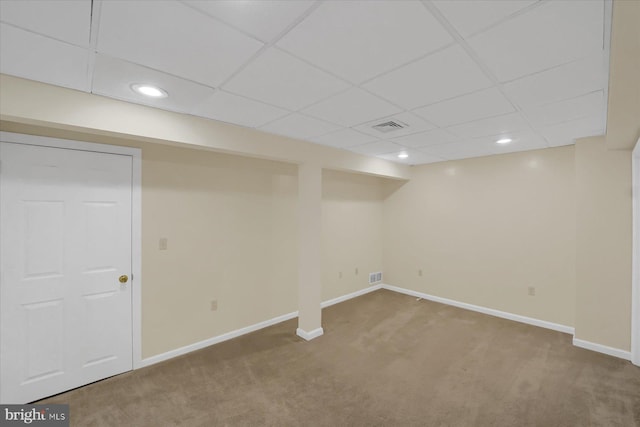 finished basement featuring baseboards, visible vents, and carpet flooring