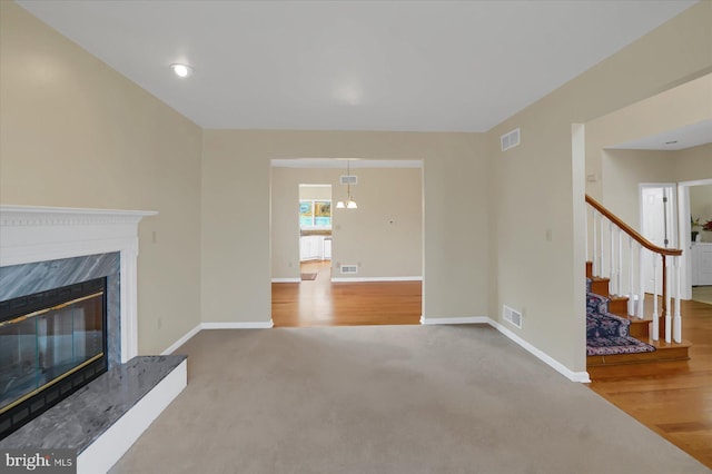 unfurnished living room featuring baseboards, a fireplace, and visible vents