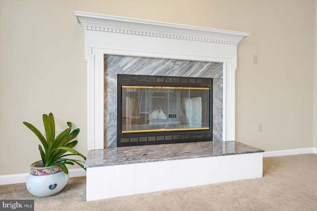 room details with carpet flooring, baseboards, and a premium fireplace