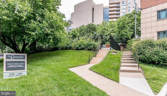 surrounding community with stairway and a yard