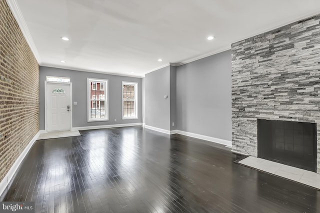 unfurnished living room with a fireplace with flush hearth, ornamental molding, and hardwood / wood-style floors