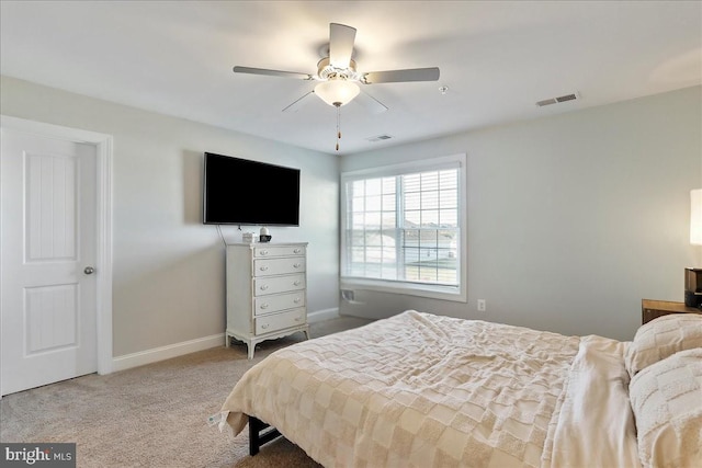 carpeted bedroom featuring visible vents, baseboards, and ceiling fan