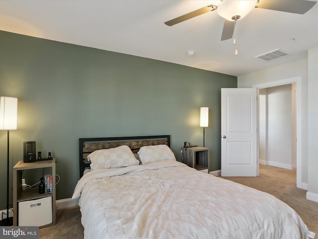 bedroom with visible vents, baseboards, ceiling fan, and carpet flooring