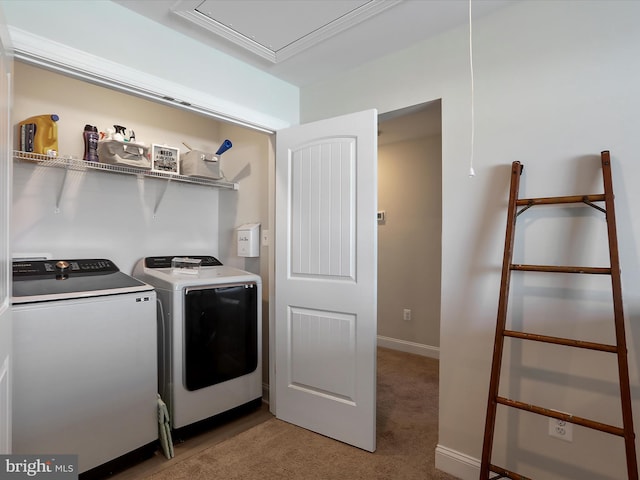 laundry area with baseboards, washing machine and dryer, light colored carpet, attic access, and laundry area