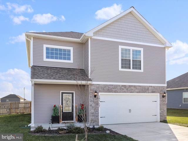 view of front of property featuring fence, roof with shingles, driveway, stone siding, and an attached garage