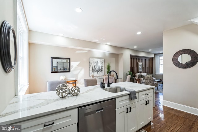 kitchen featuring dark wood-style floors, open floor plan, a sink, light stone countertops, and dishwasher