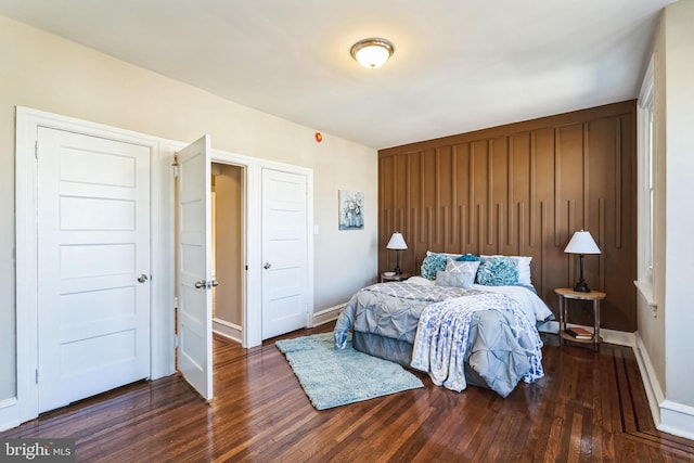 bedroom with baseboards and wood finished floors