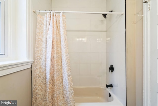 bathroom featuring shower / tub combo with curtain