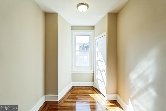 interior space featuring wood finished floors and baseboards