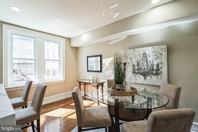 dining area featuring recessed lighting, wood finished floors, and baseboards