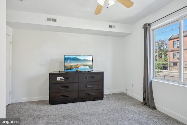 unfurnished bedroom featuring visible vents, a ceiling fan, baseboards, and light colored carpet
