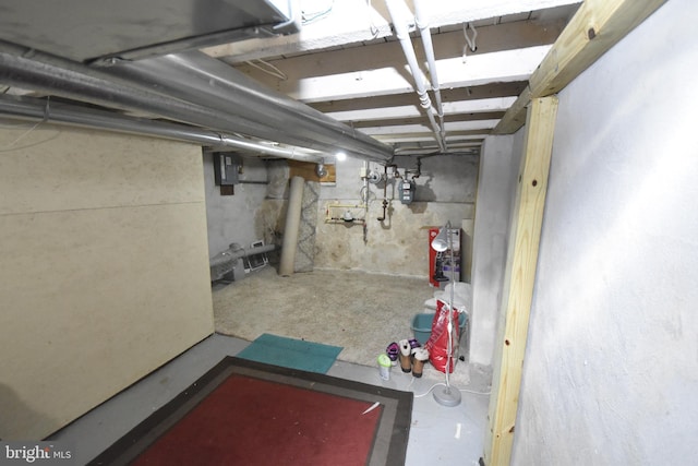 unfinished basement featuring electric panel