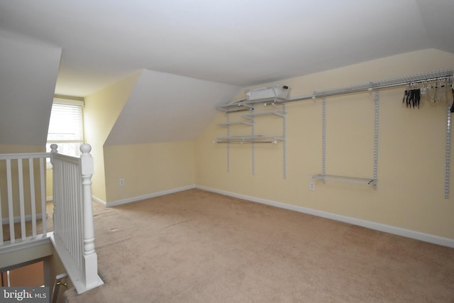 bonus room featuring carpet, vaulted ceiling, and baseboards