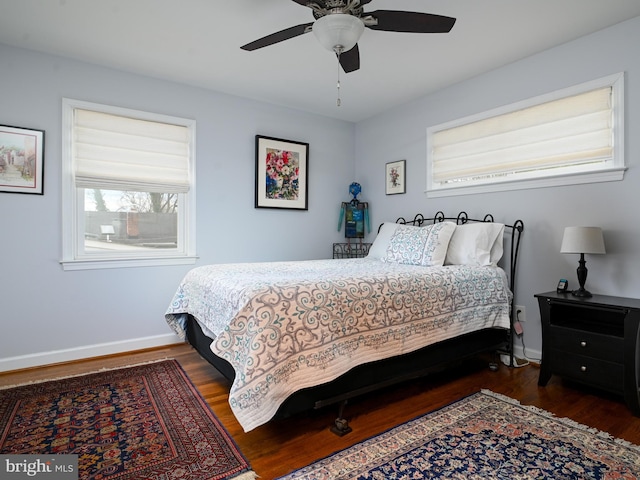 bedroom featuring wood finished floors, a ceiling fan, and baseboards