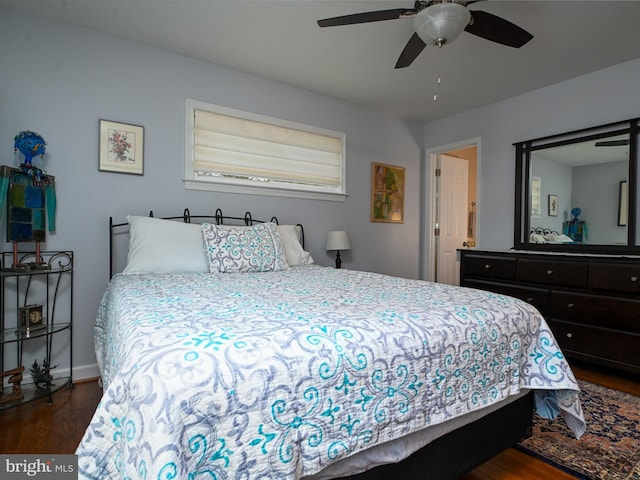 bedroom featuring a ceiling fan and dark wood-type flooring