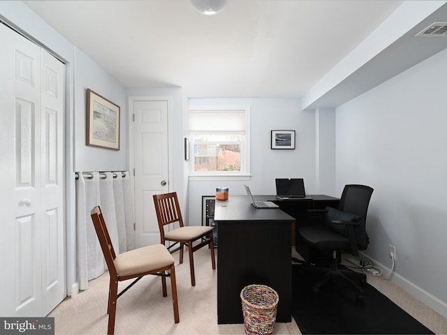 office area featuring light colored carpet, visible vents, and baseboards