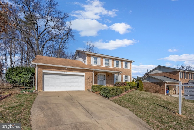 view of front of property with a garage, concrete driveway, brick siding, and a front yard