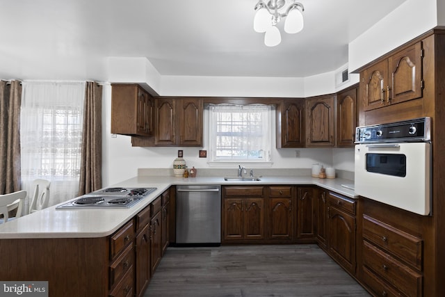 kitchen featuring appliances with stainless steel finishes, light countertops, visible vents, and a sink