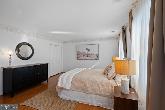 bedroom featuring a closet and wood finished floors