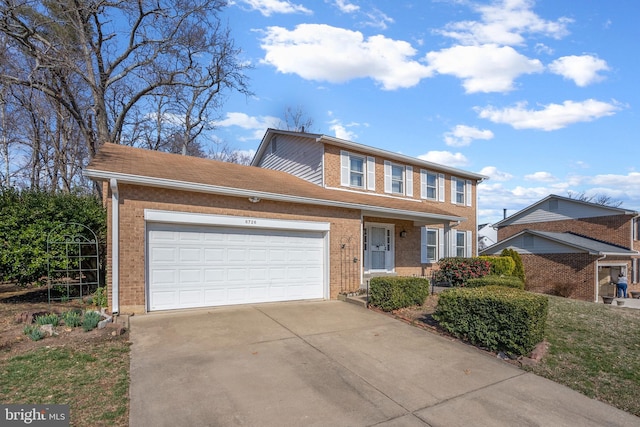 view of front of property with a garage, driveway, and brick siding