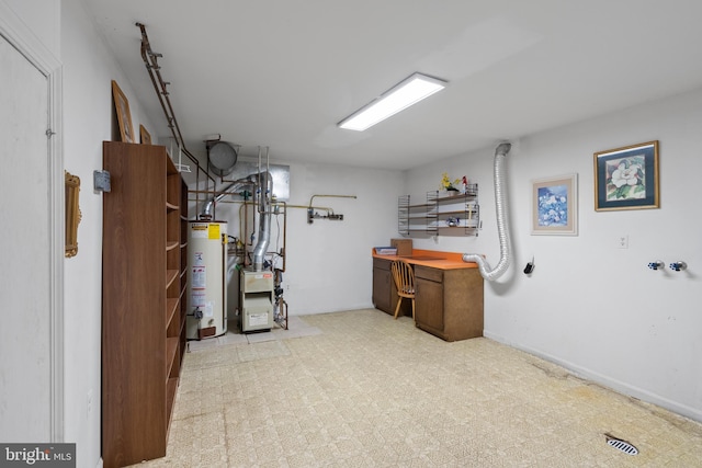 finished basement with light floors, water heater, and baseboards