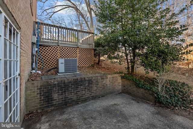 view of patio featuring cooling unit and a wooden deck