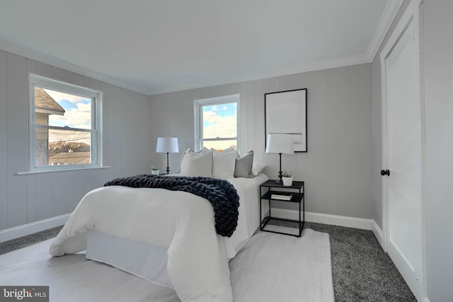 bedroom featuring baseboards, multiple windows, and crown molding