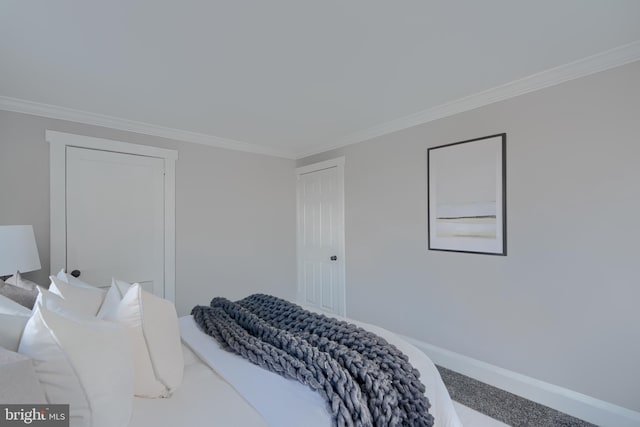 bedroom featuring carpet flooring, baseboards, and ornamental molding