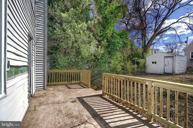 view of patio with an outdoor structure and a storage unit