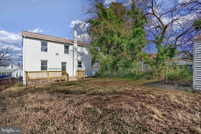 rear view of house with fence