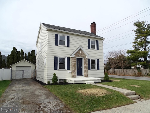 colonial-style house with a chimney, a detached garage, fence, and an outdoor structure