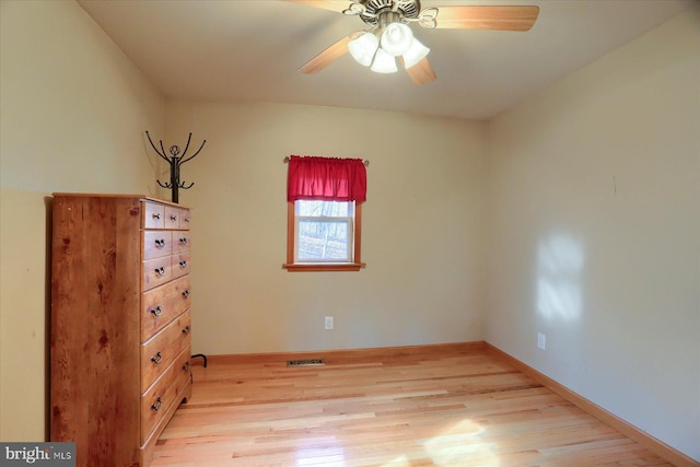 unfurnished bedroom with a ceiling fan, light wood-style floors, visible vents, and baseboards