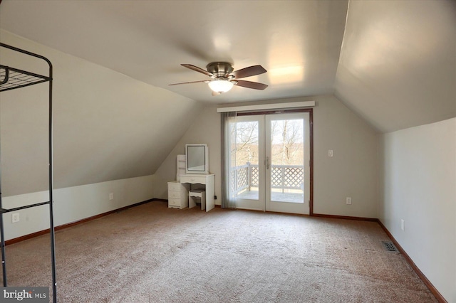 additional living space featuring visible vents, carpet floors, lofted ceiling, and baseboards