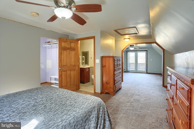 bedroom with baseboards, lofted ceiling, light carpet, and attic access