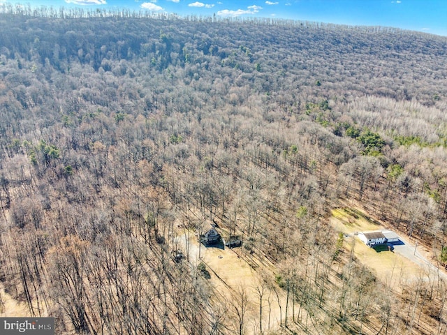 birds eye view of property featuring a wooded view