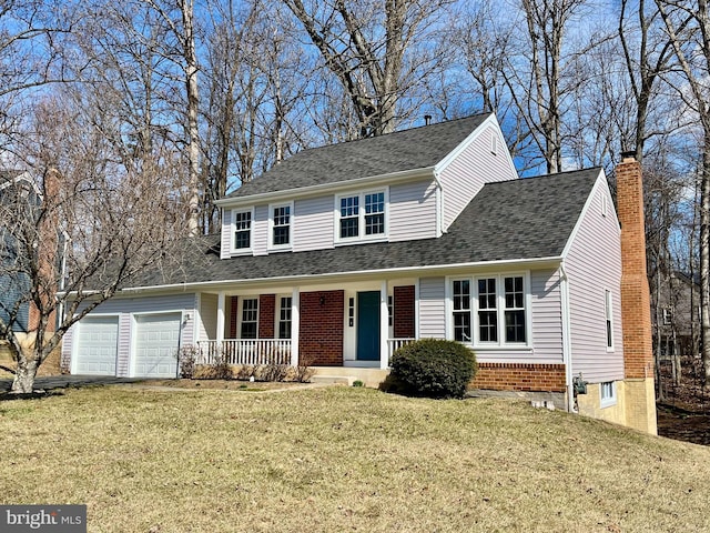 view of front of home with a shingled roof, a front yard, covered porch, a chimney, and a garage