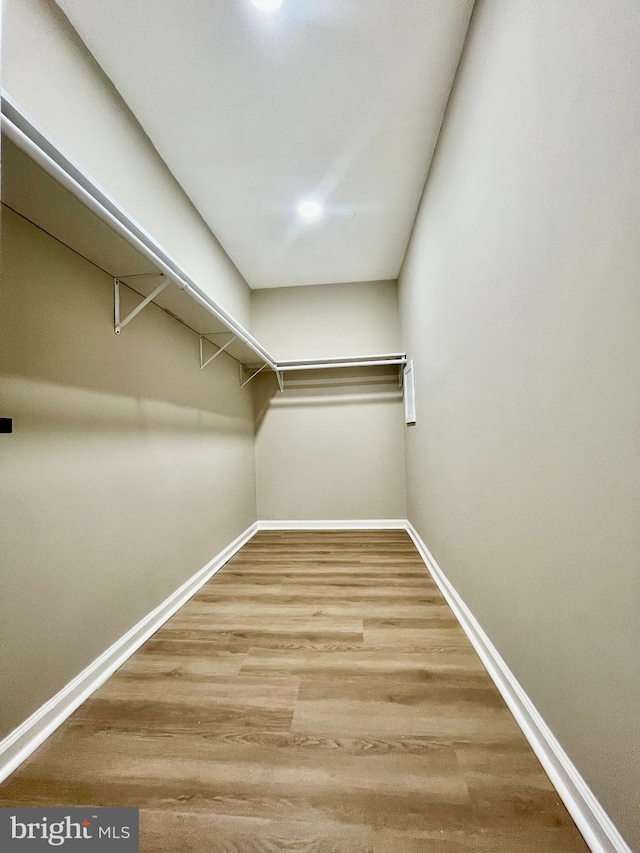 spacious closet with wood finished floors