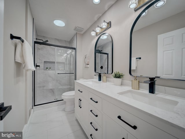 full bath featuring visible vents, toilet, a stall shower, a sink, and double vanity