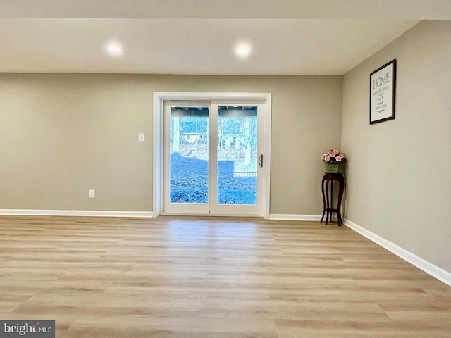 empty room featuring recessed lighting, baseboards, and wood finished floors