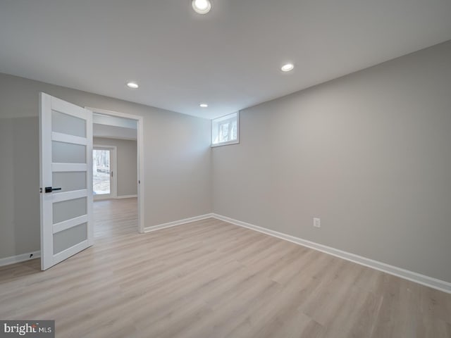 basement with recessed lighting, light wood-type flooring, and baseboards