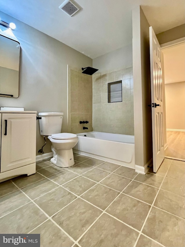 full bath featuring baseboards, visible vents, tile patterned flooring, shower / bath combination, and toilet