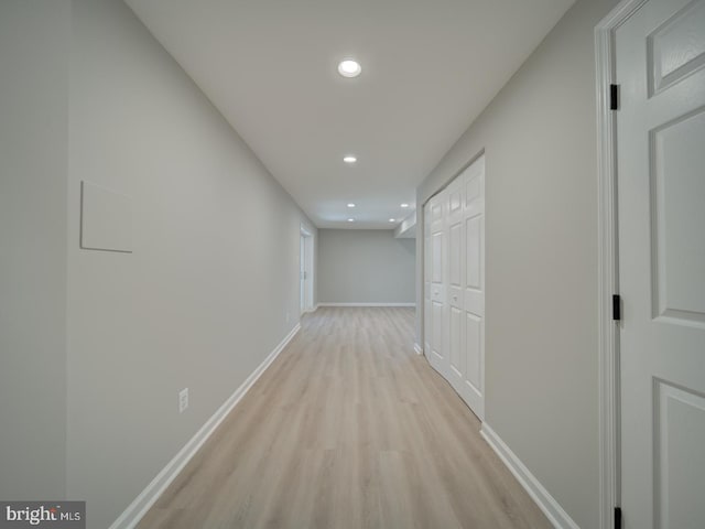 corridor with recessed lighting, light wood-type flooring, and baseboards