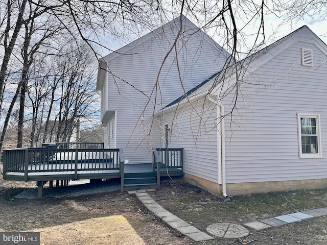 back of property with a wooden deck