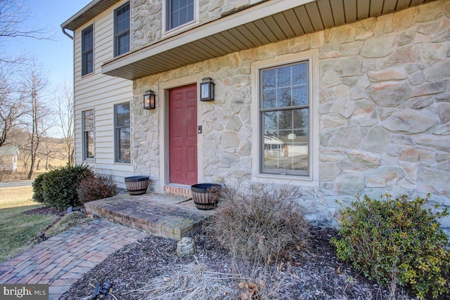 entrance to property featuring stone siding